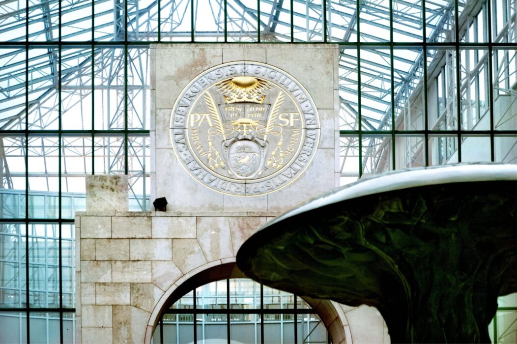 Main entrance of the Natural Science Faculty of the University of Salzburg with a round seal