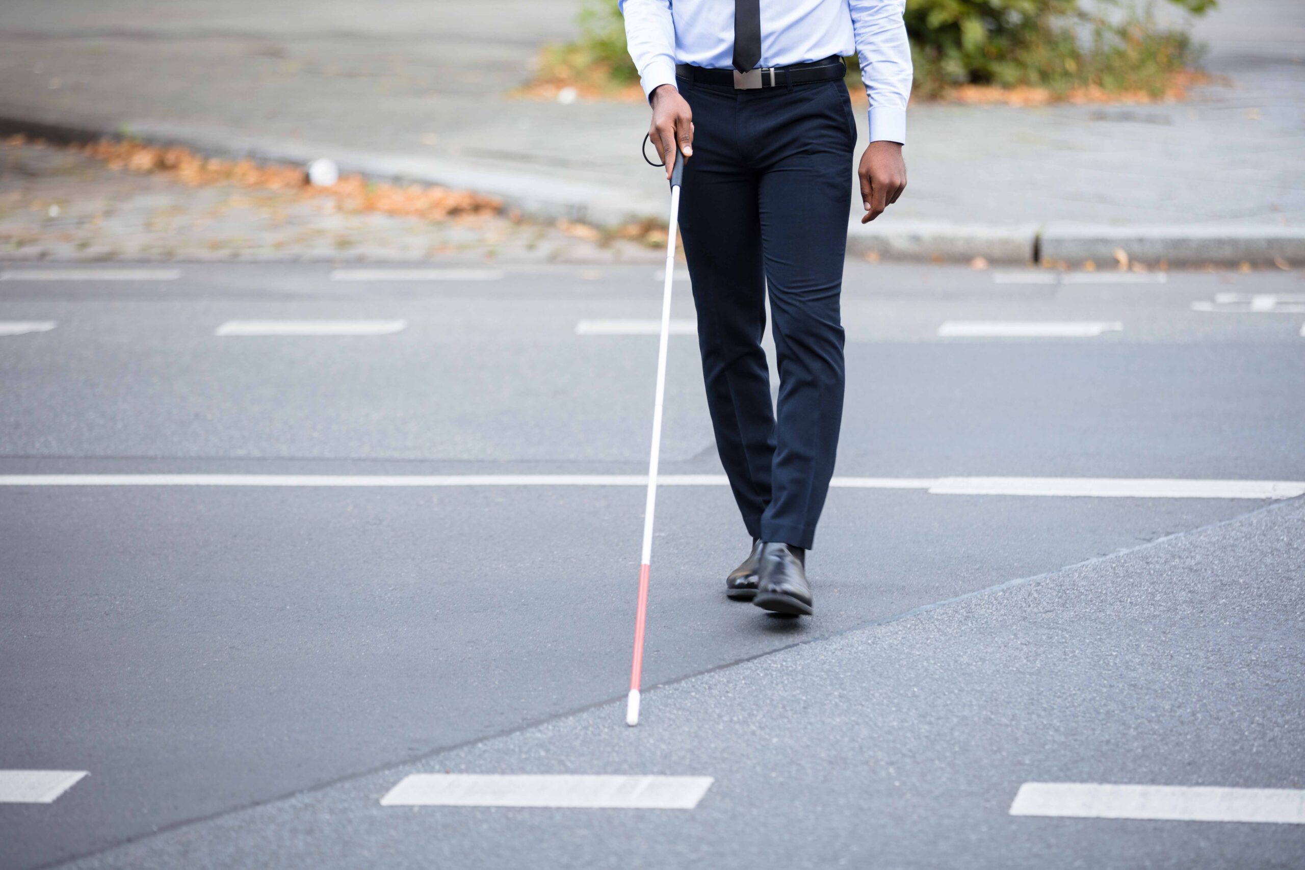 Blind Person With White Stick Walking On Street