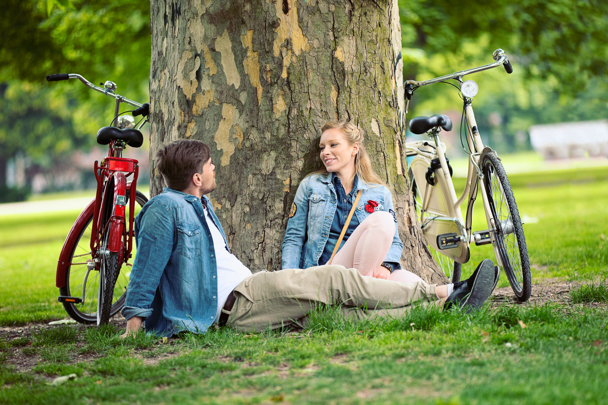 Young Couple Sitting Under Tree