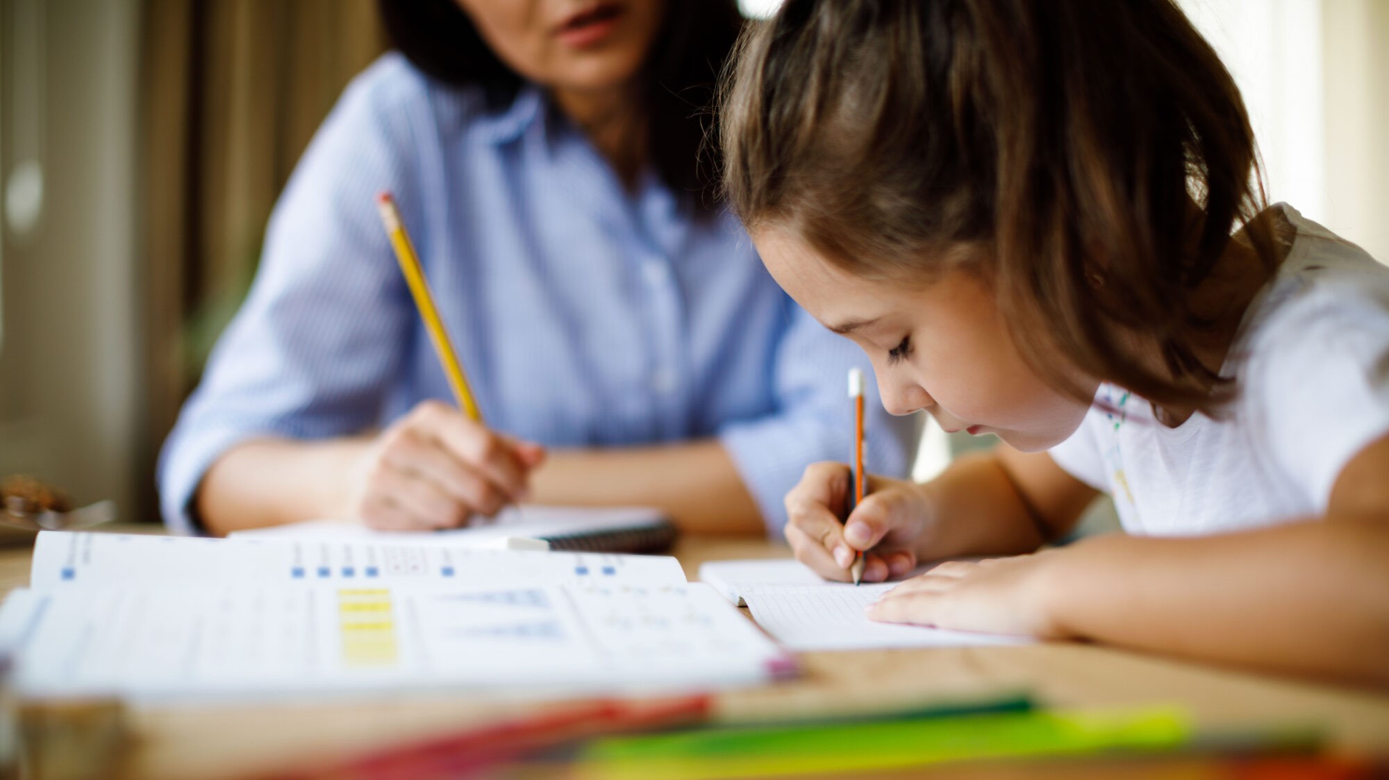 Mother helping daughter with homework