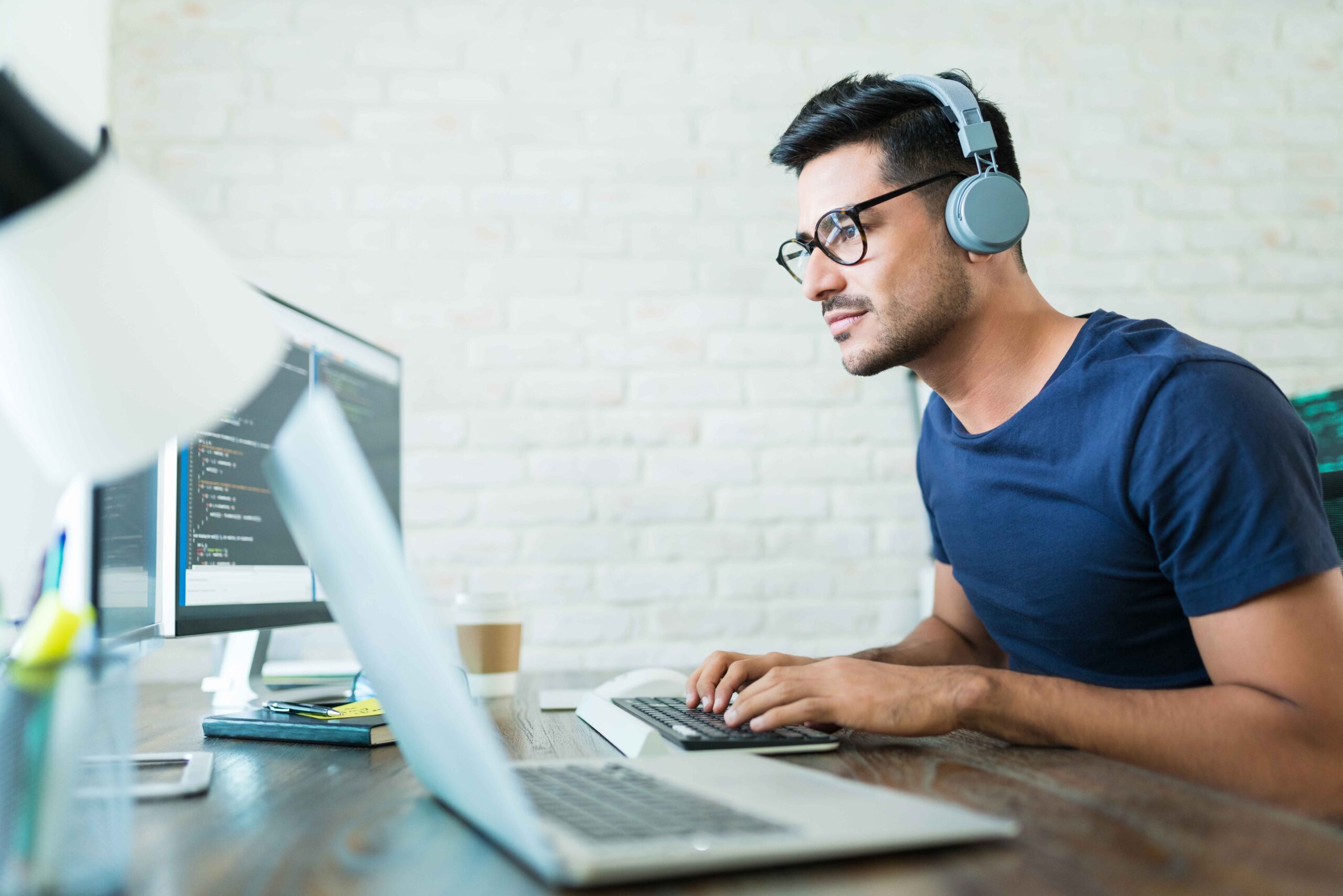 Latin Freelance Coding Expert Using Computer At Desk