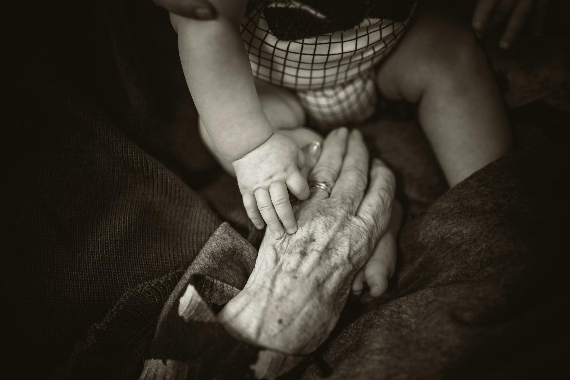 Hands of a child and an old person