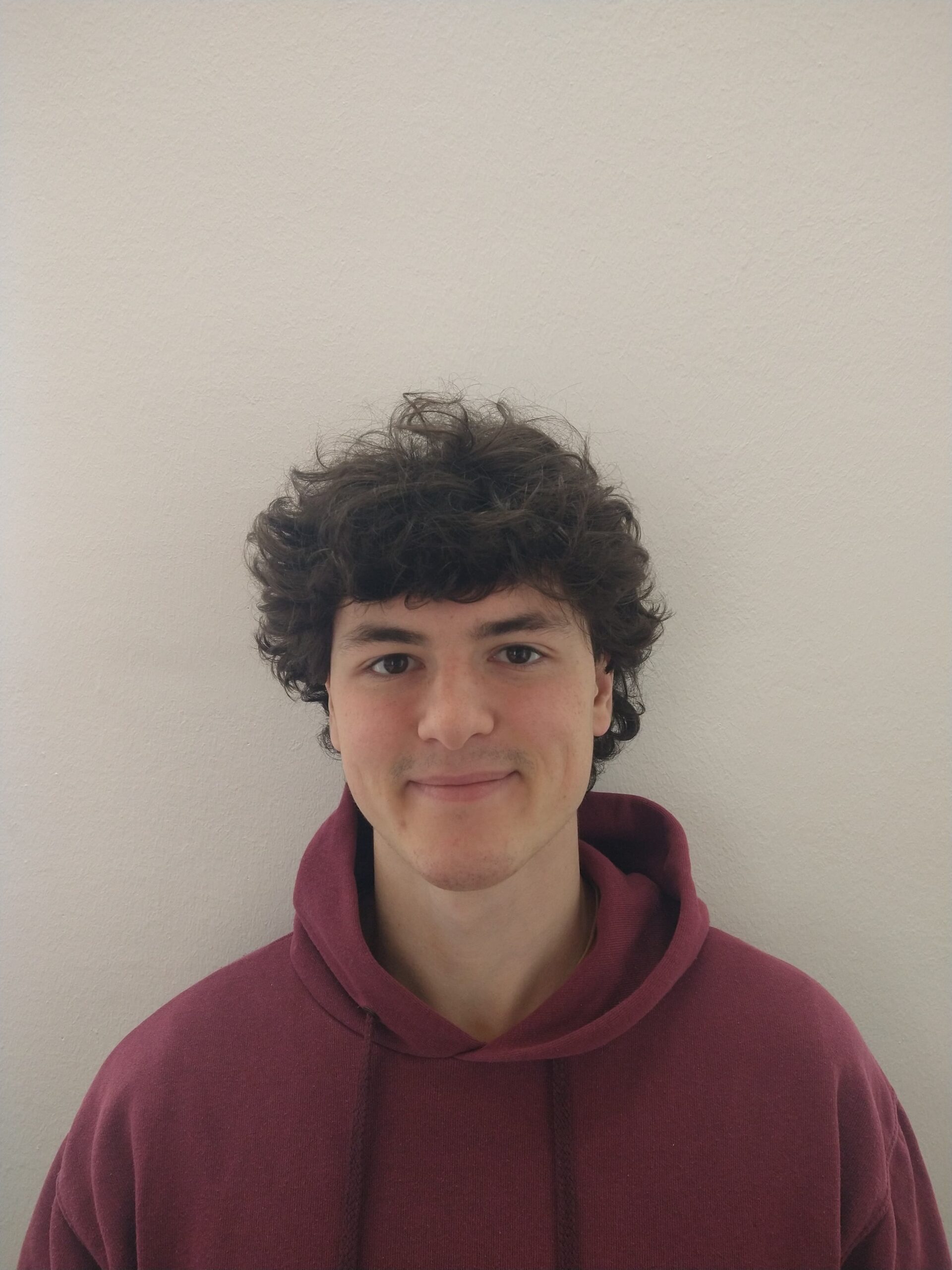 A portrait of Julian Rabl in a hoodie