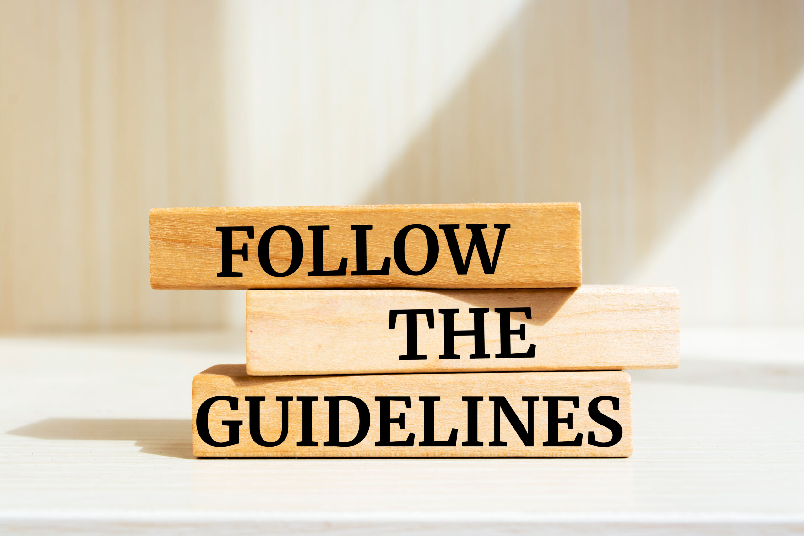 Wooden blocks with words 'Follow the Guidelines'. Business concept
