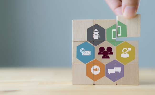 Customer engagement concept..Technology, internet, business and marketing. Marketing campaign and communication to target customer. Hand puts wooden cubes ... 