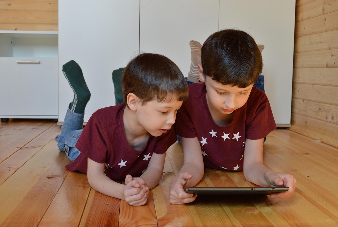 two children using a tablet