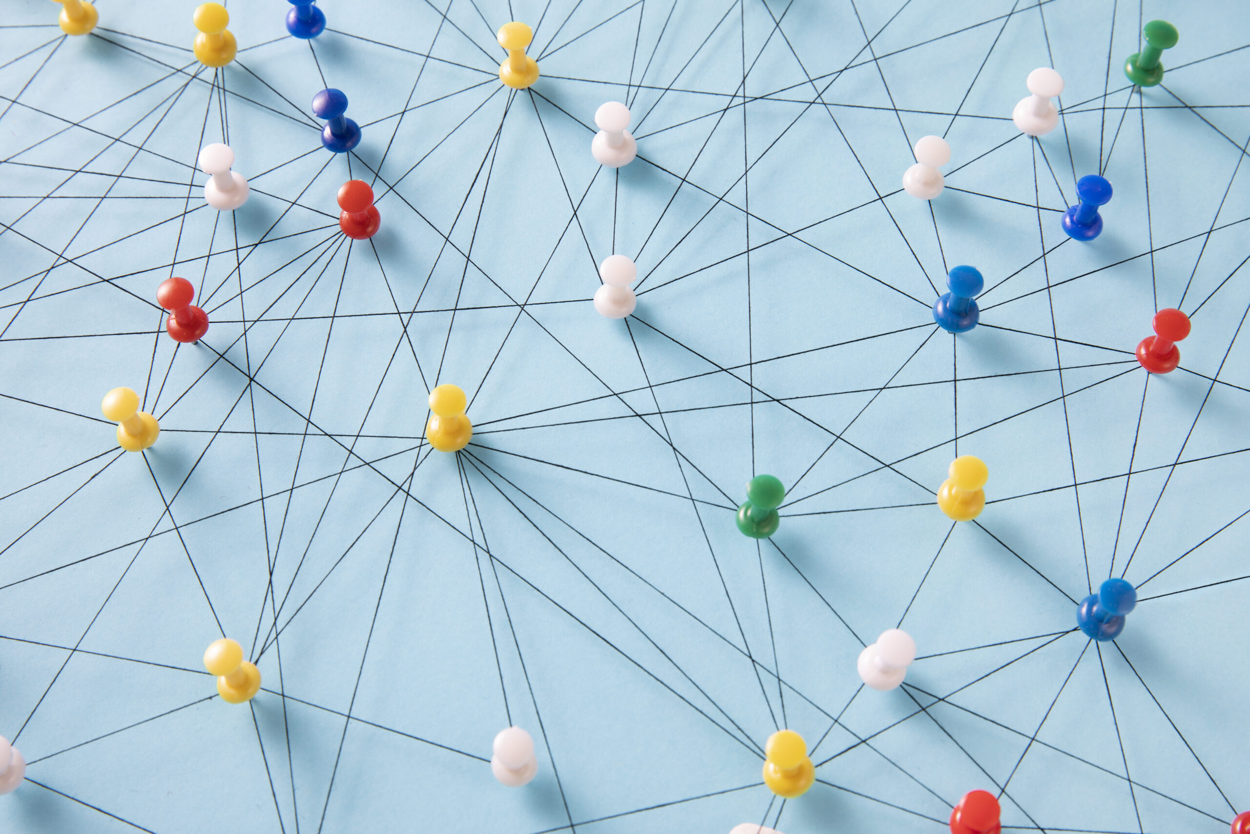 An arrangement of colorful pins linked together with string